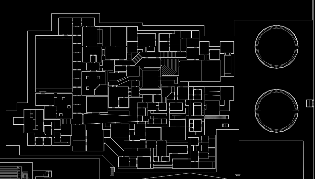This is a dark labryinth filled with twists and turns, almost impossible to see anything. On the right, there are two circular staircase looking structures